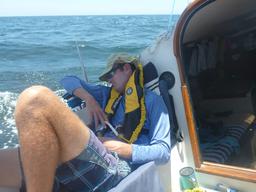 Dave sleeping in the cockpit in the shade of the mainsail.