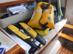 The inflated life jacket next to the uninflated one